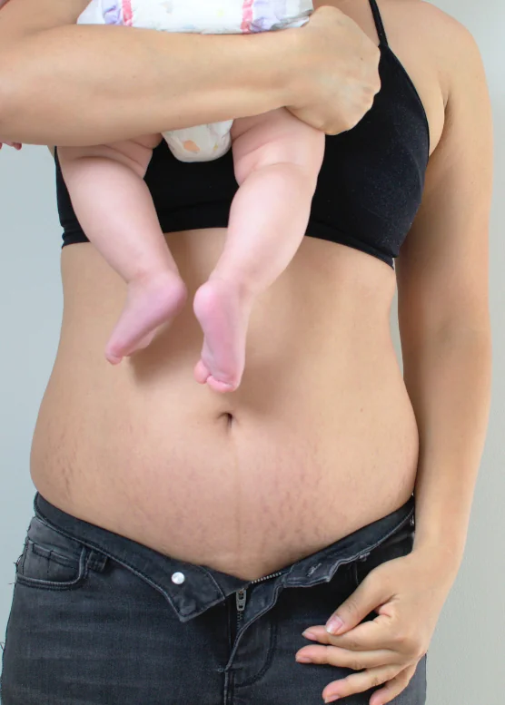 Mother holding her baby above her abdomen