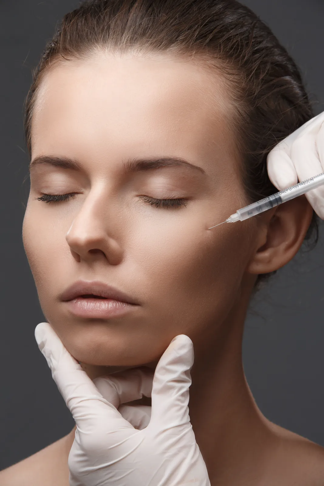 Woman receiving a cosmetic injection for expression lines, Botox and Dysport at Advanced Aesthetics