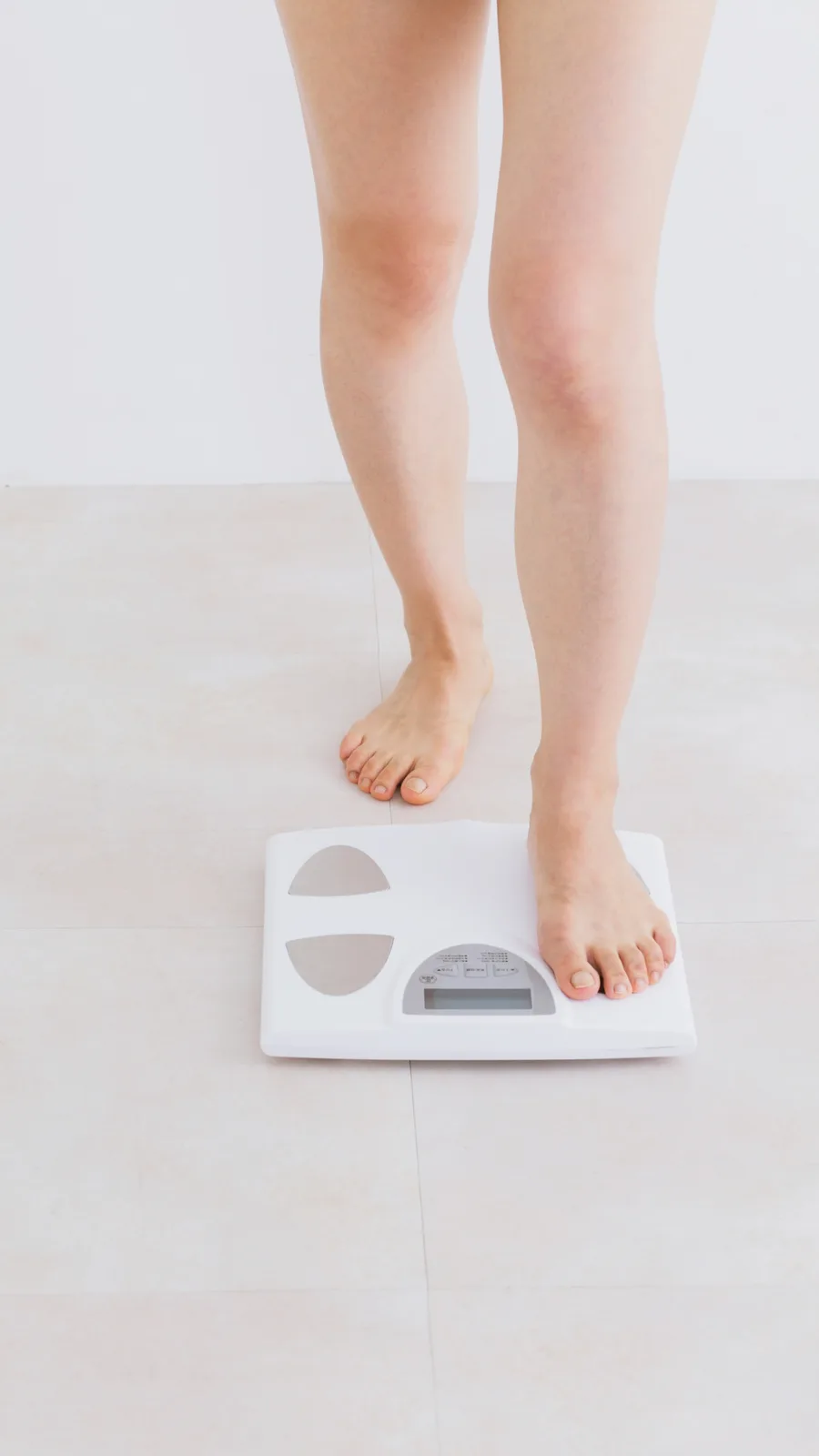 Stepping on a scale to track weight loss progress