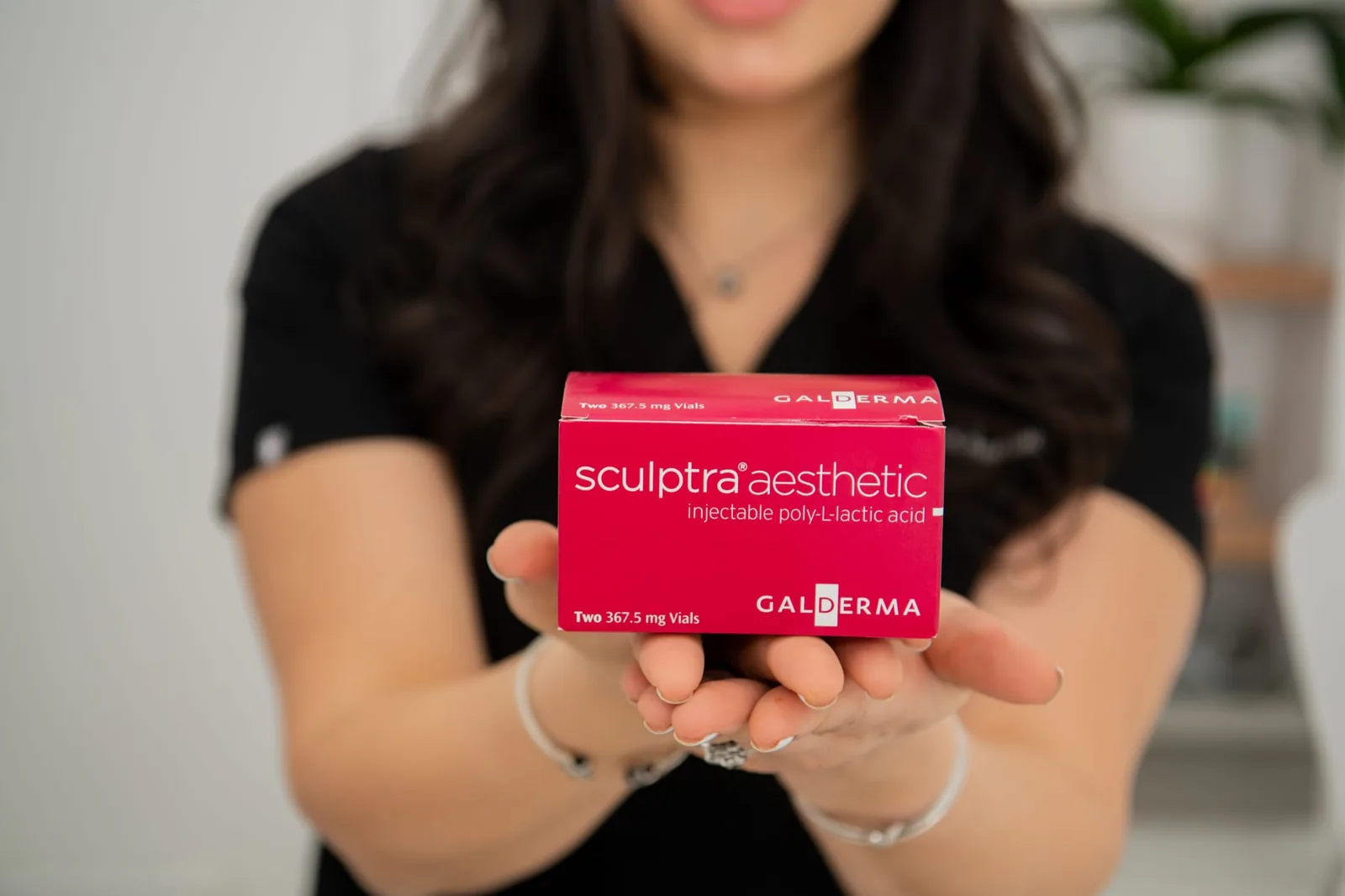 Advanced Aesthetics provider holding a box of Sculptra Aesthetic, Braintree MA