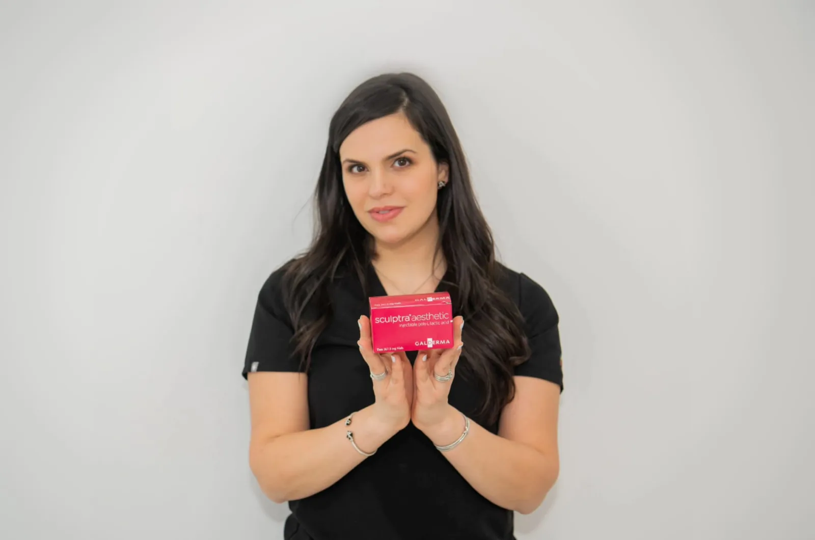 Advanced Aesthetics provider holding a box of Sculptra, Medford and Braintree MA