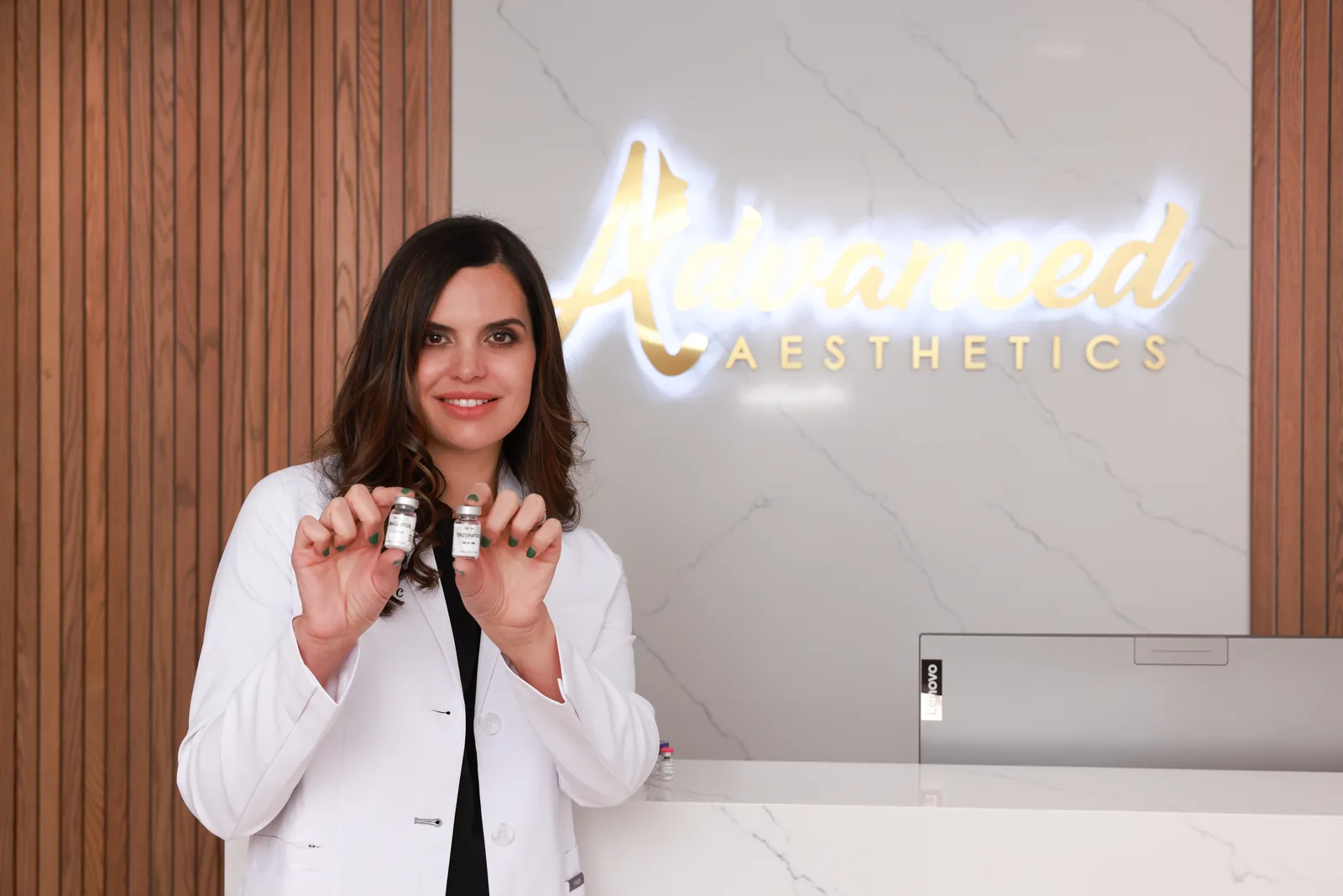 Nina Teixeira holding weight loss medication vials at Advanced Aesthetics, Medford and Braintree MA
